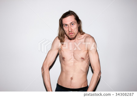 Aggressive man showing off his muscles Aggressive man showing off his muscles 34308287