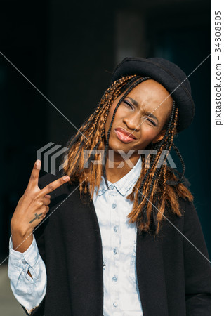 Victory gesture. Confident young black lady 34308505
