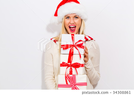 Young woman holding Christmas gifts 34308861