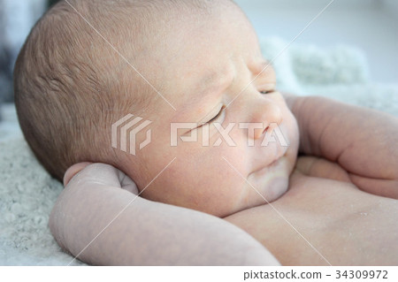 observe the silence of the concept. baby newborn closed his ears. a little one just born observe the silence of the concept. baby newborn closed his ears. a little one just born 34309972