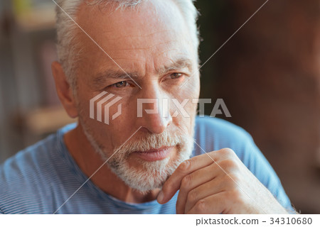 Thoughtful elderly man holding his hand on the 34310680