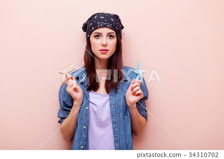 Young redhead girl in bandana holding starfish Young redhead girl in bandana holding starfish 34310702