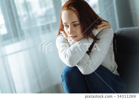 Cheerless sad woman feeling lonely Cheerless sad woman feeling lonely 34311269