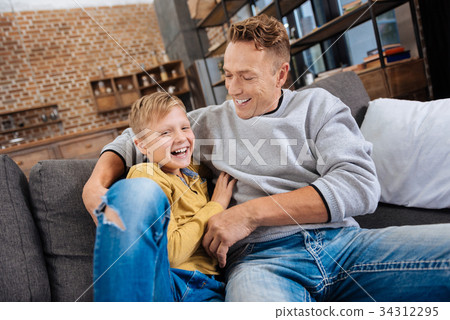 Happy father tickling his son and laughing with 34312295