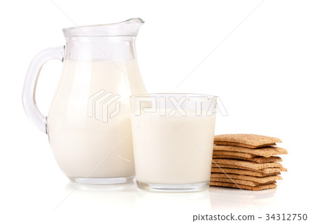jug and glass of milk with stack of grain 34312750