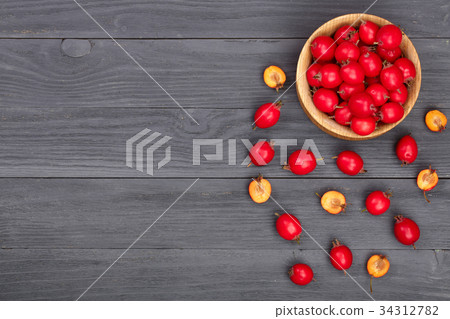 Hawthorn berry in bowl on a black wooden 34312782