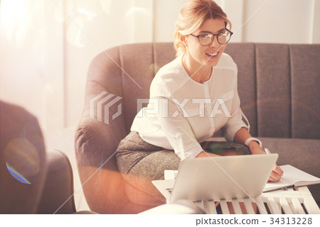 Positive cheerful businesswoman planning her day Positive cheerful businesswoman planning her day 34313228