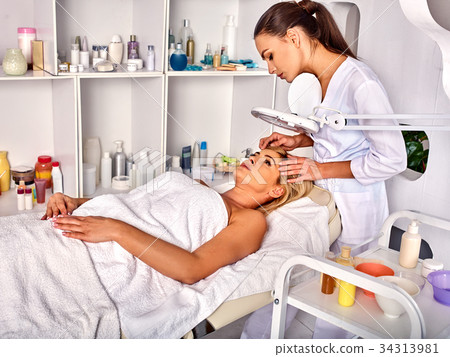 Eyebrow treatment of woman middle-aged in spa Eyebrow treatment of woman middle-aged in spa 34313981