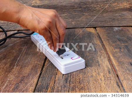 white plug socket electric power bar on wood 34314639