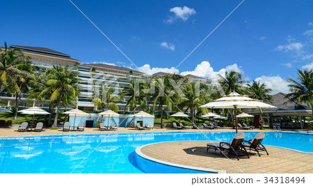 Swimming pool at luxury resort in sunny day 34318494