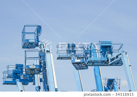 Basket of multiple forklifts old blue on blue sky 34318915