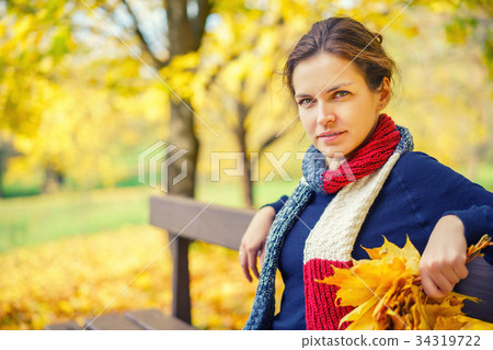 Portrait of young beautiful woman in autumn park 34319722