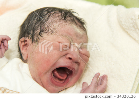 A baby just after giving birth in a maternity dress A baby just after giving birth in a maternity dress 34320126