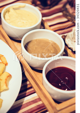 French fries with sauces on home table French fries with sauces on home table 34320431