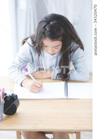 Portrait of asian cute girl doing your homework  at home 34320470