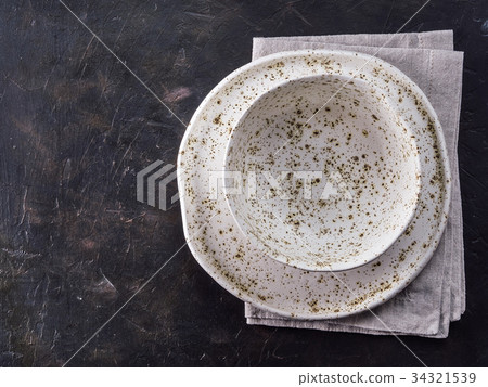 White craft plate on black slate table 34321539