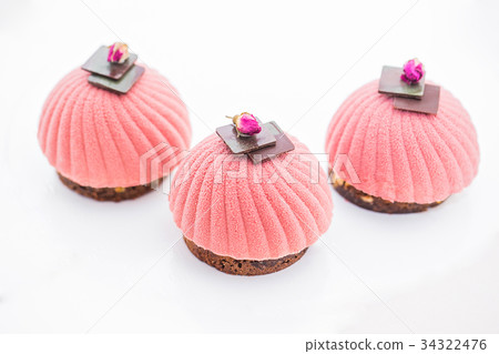 Three pink cupcake background on white 34322476