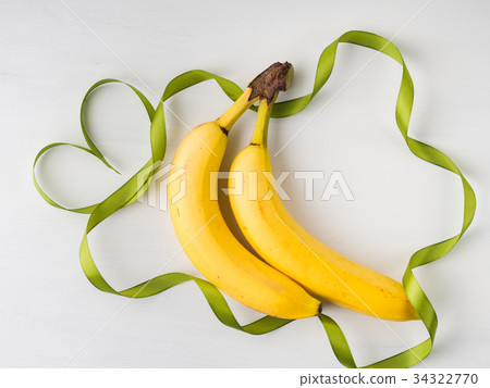 Two bananas with green ribbon frame Two bananas with green ribbon frame 34322770