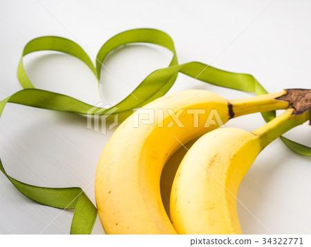 Two bananas with green ribbon frame Two bananas with green ribbon frame 34322771
