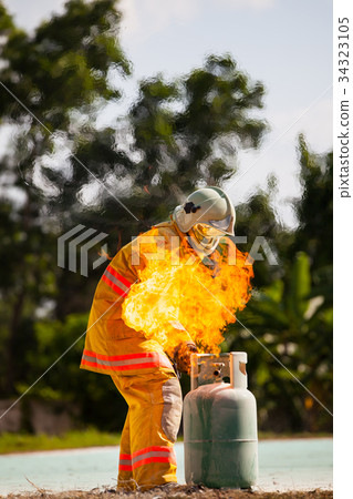 Firefighter with fire and suit for protect fire. Firefighter with fire and suit for protect fire. 34323105