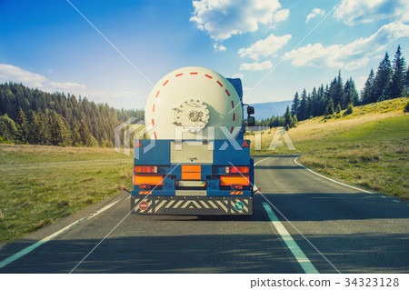 White tanker and trucks driving along the 34323128
