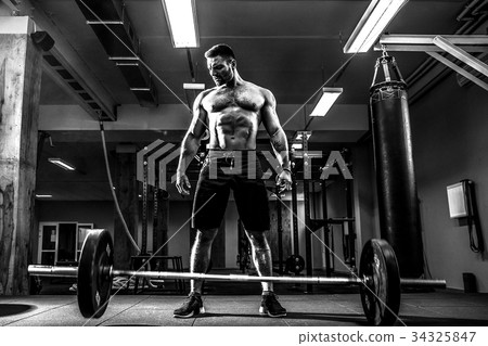 Muscular fitness man preparing to deadlift a Muscular fitness man preparing to deadlift a 34325847