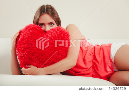 Woman hugging heart shape pillow. Valentines day. Woman hugging heart shape pillow. Valentines day. 34326729