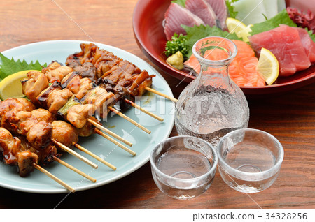 Yakitori platter. Negima, grilled chicken, skin, liver, chicken meatball, large leaves and lemon. 34328256