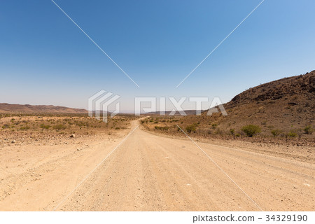 Gravel 4x4 road crossing the colorful desert 34329190