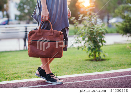 Autumn street fashion look. Young brunette girl in Autumn street fashion look. Young brunette girl in 34330358