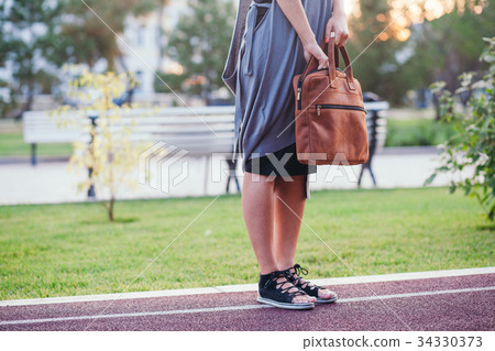 Woman searching for stuff in her handbag 34330373