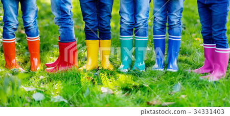 Little kids, boys and girls in colorful rain boots 34331403