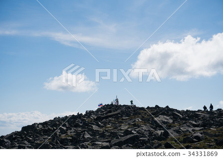 silhouettes of people on top of a mountain with a 34331869