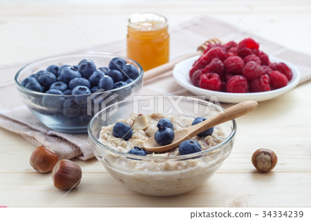 Breakfast of oatmeal with blueberries, raspberries 34334239