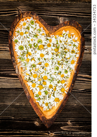 Chamomile in a wooden dish Chamomile in a wooden dish 34334753