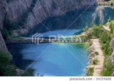 Blue lagoon at the bottom of canyon 34334806