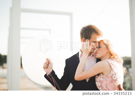 Young couple in love posing on roof with perfect Young couple in love posing on roof with perfect 34335215