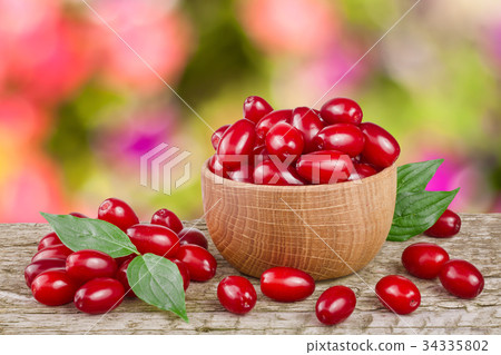 dogwood berry with leaf in bowl on wooden table dogwood berry with leaf in bowl on wooden table 34335802
