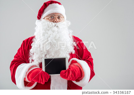 Generous Father Frost showing modern gadget Generous Father Frost showing modern gadget 34336187