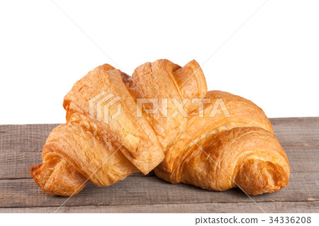 two croissant on a wooden table with white two croissant on a wooden table with white 34336208