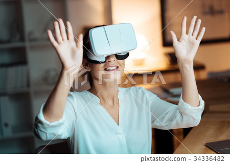Joyful woman raising her both arms Joyful woman raising her both arms 34336482