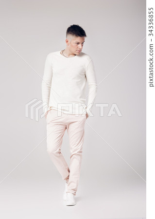 handsome young man in a white sweater and pants  34336855