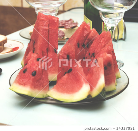Slices of a ripe watermelon on a festive table 34337051