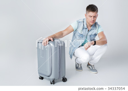 young man in blue shirt with suitcase young man in blue shirt with suitcase 34337054