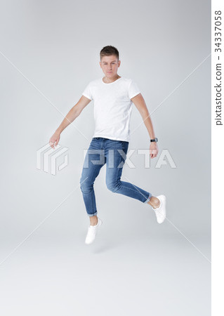 handsome man in jeans and jacket jumping handsome man in jeans and jacket jumping 34337058