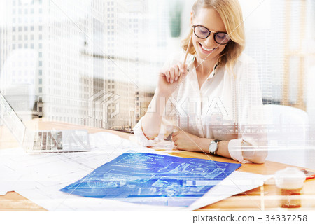 Smiling designer working at the table 34337258