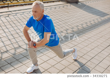 Athletic senior man warming up before morning run 34338271