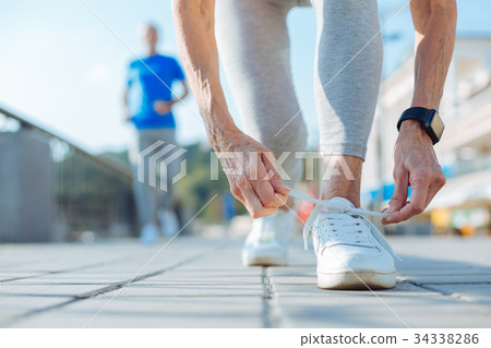 Close up of elderly woman tying shoelaces on Close up of elderly woman tying shoelaces on 34338286