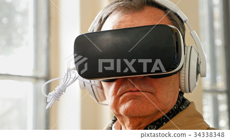 Senior old man wearing VR headset Senior old man wearing VR headset 34338348