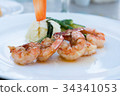 grilled shrimps or skewer on plate with salad 34341053